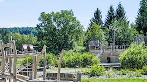 A playground with wooden structures and a slide. - Jägerwiesen ND 4 by Interhome (Waldkirchen)