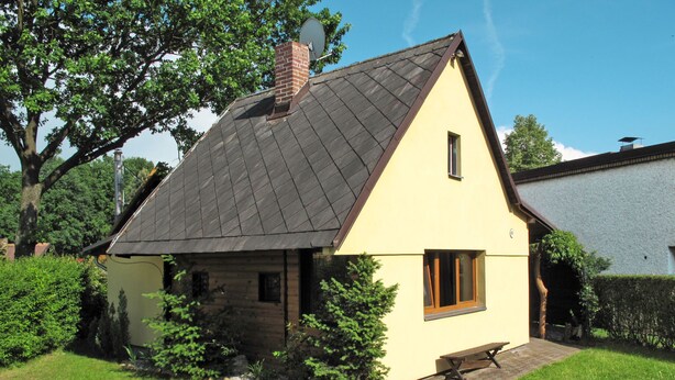 A single-story house with a sloped roof, a brick chimney, and a small window. - Vacation home Jiri by Interhome (Dehtáře)