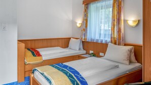 A double room with two beds, a window with curtains, and a wall-mounted light fixture. - Apartment Markus by Interhome (Zell am Ziller)