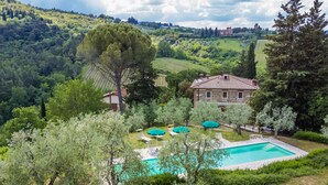 A villa with a swimming pool, surrounded by lush greenery and hills. - Policleto by Interhome (San Polo in Chianti)