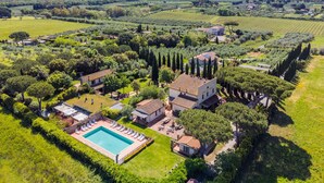 An aerial view of a countryside property with a swimming pool, multiple houses, and surrounding greenery. - Podere Tre Termini by Interhome (Cecina)