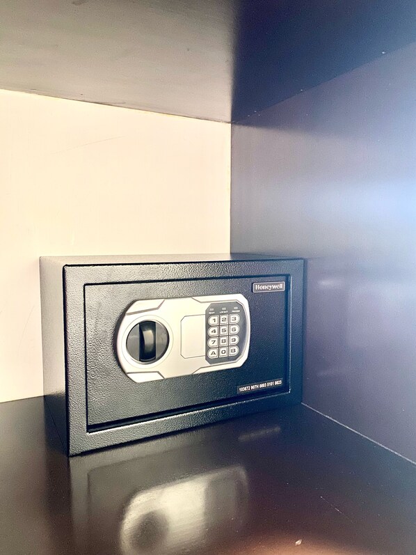 A black safe with a keypad and a lock button, labeled "Honeywell."
