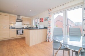 Enjoy meals in this kitchen with stainless steel appliances, a central island, and a dining table for two.