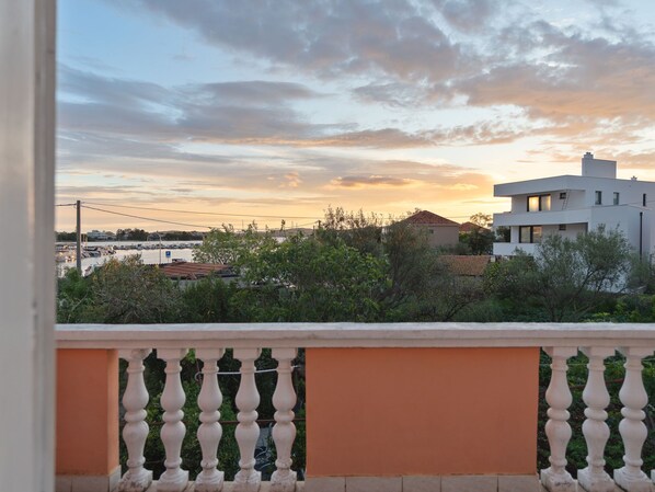 A balcony with a railing, overlooking a marina with boats and buildings. - Marijana by Interhome (Zadar)