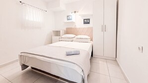 A bedroom with a bed, a nightstand, a wardrobe, and a ceiling light. - Gottwald by Interhome (Starigrad-Paklenica)