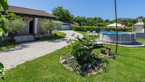 A stone house with a tiled roof, a swimming pool, and a garden with a gravel path. - Apartment Cekić by Interhome (Rovinj)