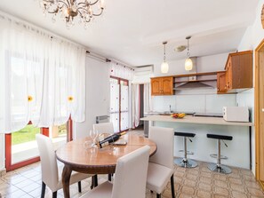 Enjoy a spacious living and dining area with a large window offering a view of the outdoor space.