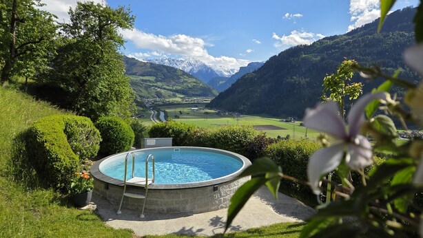 A swimming pool with a view of mountains and a valley.