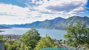 A mountainous landscape with a lake and a town in the valley.