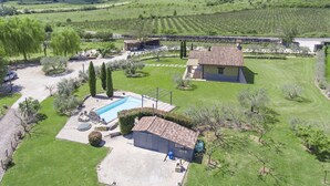 A residential property with a swimming pool, a tennis court, and a vineyard in the background. - Cipresso by Interhome (Lago di Vico)