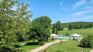 A rural setting with a clear path leading to a pool area, surrounded by lush greenery and trees. - Le Cascatelle by Interhome (Massa Marittima)