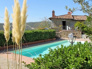 A pool area with a stone building, a stone staircase, and a view of the hills. - Montechioccioli by Interhome (Gaiole in Chianti)