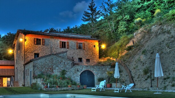 A stone building with a swimming pool, outdoor seating, and a hillside backdrop. - La Fonte by Interhome (Dicomano)