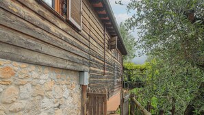 A rustic wooden building with a stone wall and a wooden door. - La Grotta by Interhome (Camaiore)