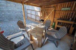 An outdoor patio with a wooden table and chairs, a grill, and a sign indicating a dry county brewing company. - Pet-friendly home minutes from Downtown/UGA Campus (Athens)