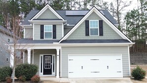 A two-story house with a garage, a front door, and a small porch. - Pet-friendly home minutes from Downtown/UGA Campus (Athens)