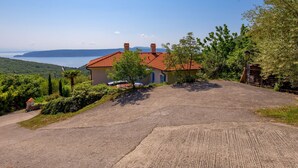 A house with a red-tiled roof, a paved driveway, and a view of the sea. - Albertina by Interhome (Mošćenička Draga)