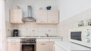 A modern kitchen with a stainless steel range, built-in oven, microwave, and a coffee maker. - Apartment Nena by Interhome (Poreč)