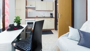 A compact living space with a kitchenette, a dining area, and a seating area. - Apartment Nena by Interhome (Poreč)