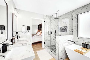 A modern bathroom with a marble vanity, a shower with a glass enclosure, and a bathtub. - LUX 7BA/4BA Oasis w/Heated Pool+Spa+Outdoor Living (Las Vegas)