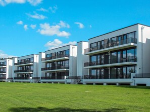 A modern building with multiple balconies and large windows.