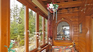 A cozy room with large windows, a patterned sofa, and a wooden ceiling. - Walcher by Interhome (Ramsau am Dachstein)