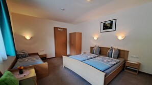 A hotel room with a bed, a desk, a chair, and a wardrobe. - Haus Alina by Interhome (Tux)