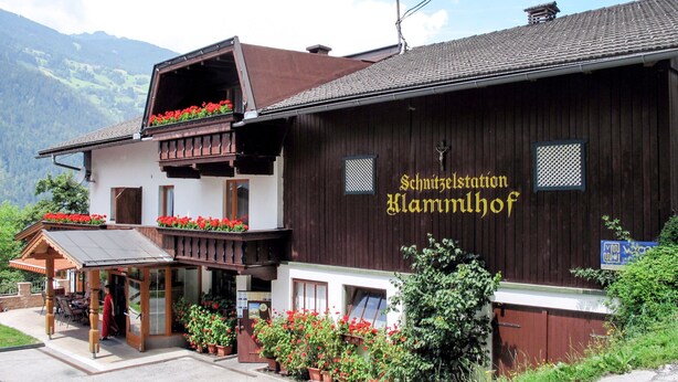 A traditional wooden building with a balcony and flower boxes, labeled "Schnitzelstation Klammlhof." - Klammlhof by Interhome (Zell am Ziller)