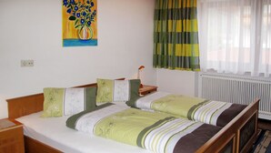 A double bed with a wooden frame, a nightstand with a lamp, and a painting on the wall. - Elisabeth by Interhome (Zell am Ziller)