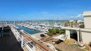 A marina with boats docked, a clear sky, and a view of the sea. - La Marina by Interhome (Scarlino)