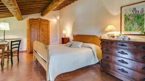 A bedroom with a wooden bed, a dresser, a desk, and a chair. - Antico Borgo S Lorenzo Cipresso by Interhome (Colle Val d'Elsa)
