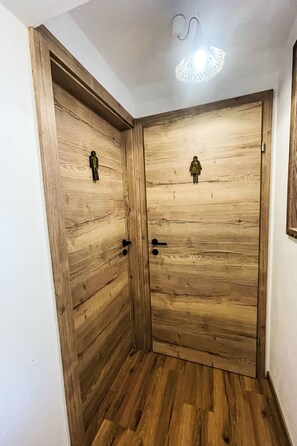 A wooden door with a simple latch and a small figure on the door. - Knaushof by Interhome (Ramsau am Dachstein)