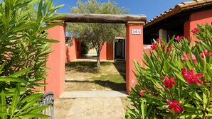 A courtyard with a stone pathway leading to a building marked with the number 10A. - Ville San Pietro (REI355) by Interhome (Costa Rei)