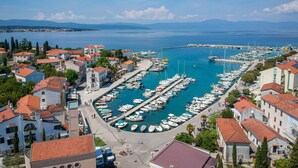 A marina with boats docked, surrounded by buildings with red-tiled roofs. - Apartment Mia by Interhome (Krk/Malinska)