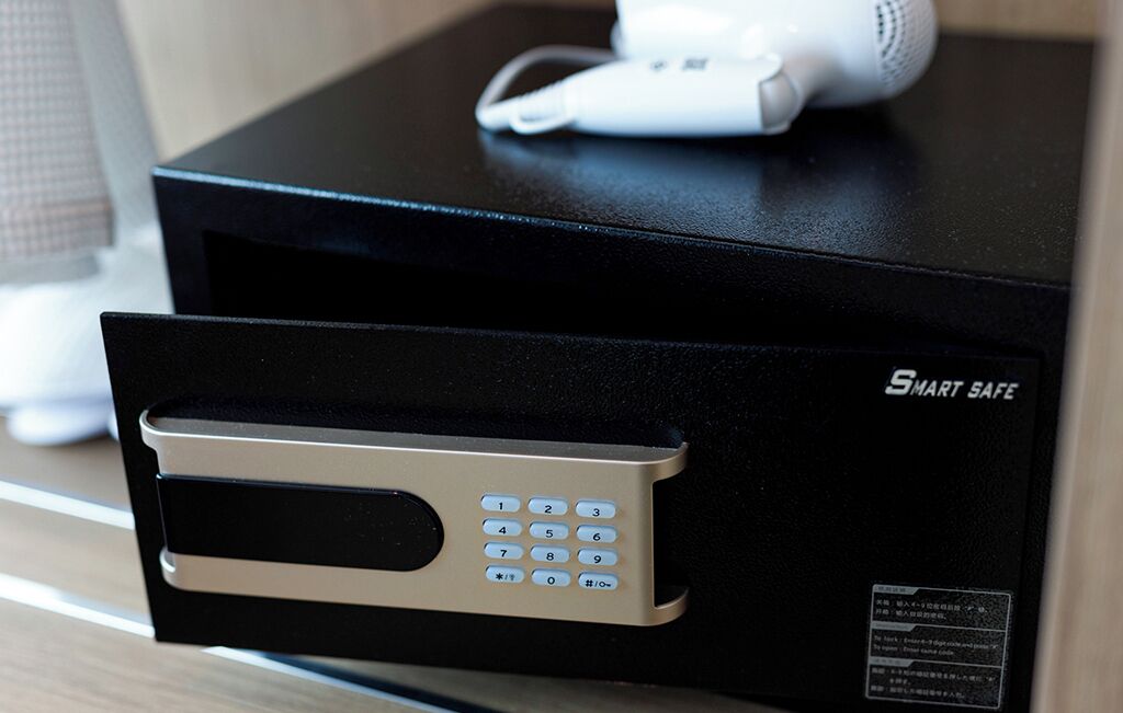 A black electronic device with a keypad and a white device on top.