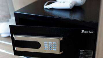 A black electronic device with a keypad and a white device on top.