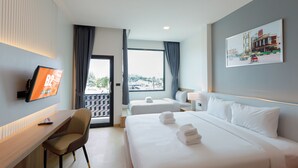 A hotel room with a desk, two beds, a TV, and a large window with curtains. - B2 Udon Premier Hotel (Udon Thani)