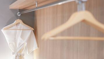 A wooden hanger with a white garment hanging from it.