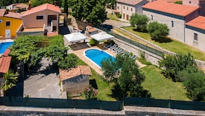 A villa with a swimming pool, stone walls, and a view of the surrounding landscape. - Villa San Giacomo by Interhome (Poreč/Kaštelir)