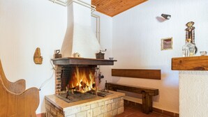 A fireplace with a stone base, a wooden bench, and a wooden ceiling. - Villa San Giacomo by Interhome (Poreč/Kaštelir)