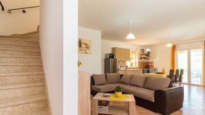 A modern living room with a sofa, coffee table, and a staircase. - Vacation home Antoni by Interhome (Pićan)