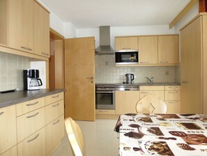 Enjoy cooking in this kitchen with a microwave, stainless steel oven, and coffee maker.