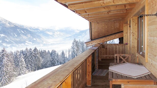 A wooden cabin with a balcony overlooking a snowy mountain landscape. - Apart Vorwies by Interhome (Fügen)