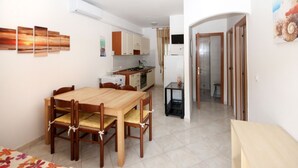 A compact living space with a dining area, kitchenette, and a small bathroom. - Casa Debora by Interhome (Rosolina Mare)