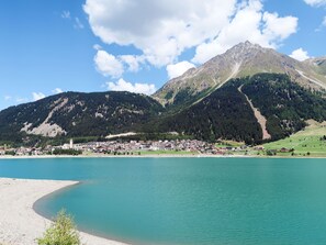 A lakeside town with a mountain backdrop, featuring a mix of residential and commercial buildings, a clear sky, and a calm lake. - Haupthaus Schönblick (SVH118) by Interhome (St Valentin/San Valentino)