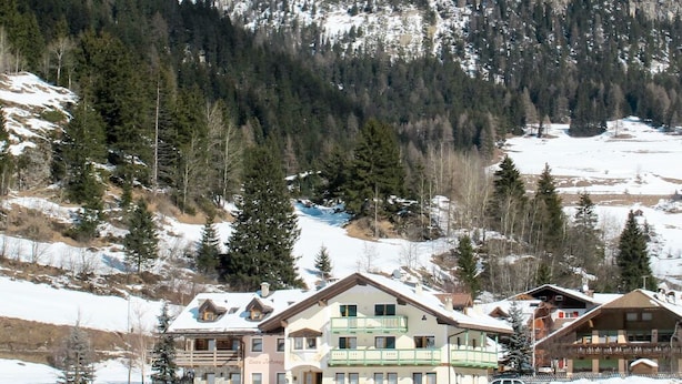 A mountain lodge with a snow-covered landscape, a clear sky, and a view of the surrounding mountains. - Ardoney by Interhome (Campitello)