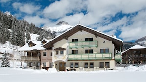 A multi-story hotel with a balcony, surrounded by snow-covered mountains. - Ardoney by Interhome (Campitello)
