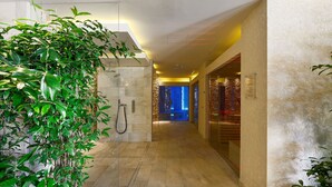 A modern hotel corridor with a glass-enclosed shower, a potted plant, and a stone wall. - Poiano Resort Appartamenti by Interhome (Garda)