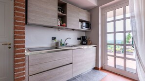 A modern kitchen with a built-in microwave, a coffee maker, and a sink.