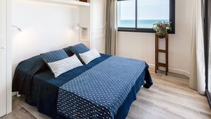 A bedroom with a bed, a window with a view of the sea, a plant on a side table, and a ladder. - La Palangre by Interhome (Argelès sur Mer)